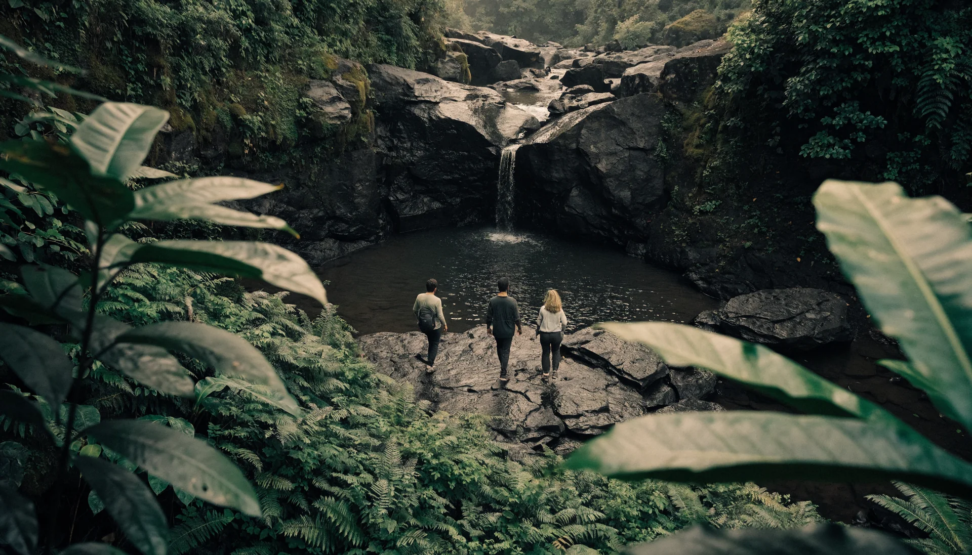 Three friends from behind approaching a natural jungle waterfall in Bali